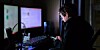 Teenaged boy on computer in his room late at night