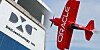 Combination of the DXC logo on a building and the Oracle logo on a plane