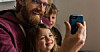Family using a smartphone together for a video call