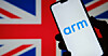 The Arm logo on a phone over the British flag