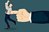 A giant hand pushing at business executive