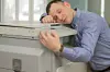 man hugs printer