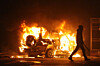 Dissident walking away from burning vehicle