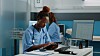 woman wearing nurse's scrubs w tablet