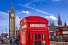 London - Iconic Red telephone box with Big Ben at the background and blue sky - UK, England. Photo by Shutterstock