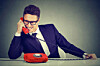 Pushy young salesman business man advertising his best product on a phone