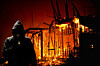 arsonist in front of burning building