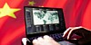 Chinese flag behind laptop with world map