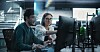 Two developers collaborating around a PC