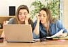 fed up uni students looking at failing laptop
