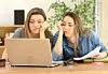 fed up uni students looking at failing laptop