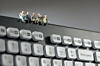 Figures of workers have a coffee break on a keyboard