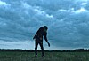 A zombie shambling across a field