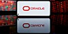 Oracle logo on smartphone floating over stock market data feeds