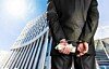 A businessman in handcuffs