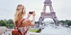 Someone taking a photo of the Eiffel Tower using their smartphone