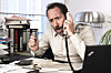 Upset man at desk shouts into phone. Pic: Shutterstock