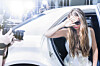 Celeb exits car while paparazzi try to take her picture