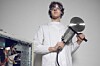 Techie wields circular saw while standing over the innards of a workstation. Photo by Shutterstock