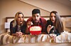 Friends look shocked watching TV. photo by Shutterstock