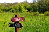 sign post pointing to trail in two different directions