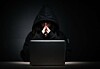 A hacker pondering at their laptop