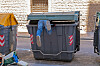 legs sticking out of a dumpster