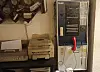 An old telephone switchboard next to a fax machine and typewriter