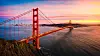 Golden Gate Bridge at sunset overlooking San Francisco Bay and distant city skyline