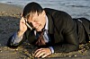 calling from cellphone, wet on a beach. Pic credit Andrew Lever / Shutterstock