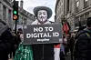 Protester in a Guy Fawkes mask holds a NO TO DIGITAL ID sign during a march in London.