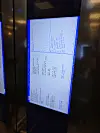 Digital display in a hotel elevator shows an American Megatrends BIOS setup screen.