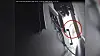 Image depicts CCTV footage from a camera situated behind the TV into which the recording device was placed, appearing to show Alfozan surprised to see the bug was no longer in place.