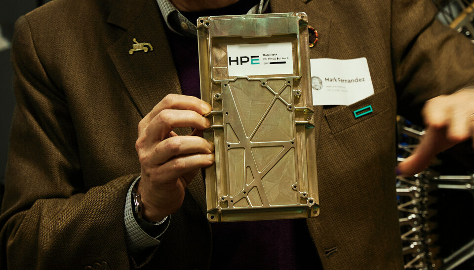 Mark Fernandez, HPE’s chief scientist of space tech and solutions, holds up the Spaceborne Computer 4 which will power the FLIP rover's AI and HPC experiments once it makes it to the moon.