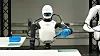 A robotic humanoid torso performs tasks